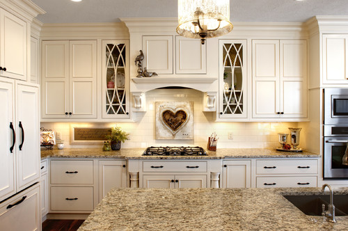 Giallo Napoli Countertop with Off White Cabinets and , Cream Subway Tiles and Dark Color Flooring